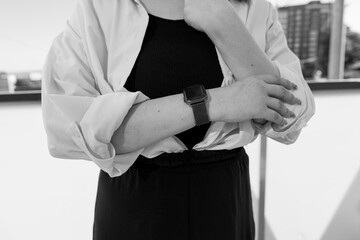 Fototapeta premium Modern Style and Elegance: Woman Wearing Smartwatch in Black and White Composition