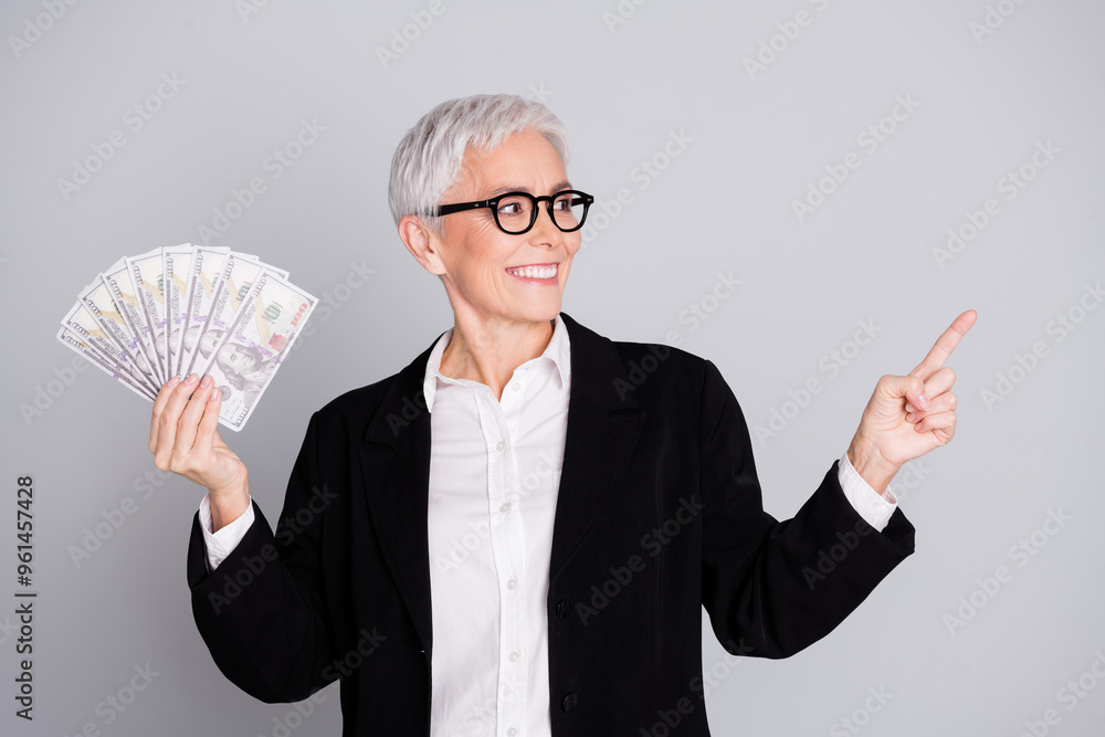 Sticker Photo of attractive mature woman professional ceo money fan point look empty space dressed formalwear isolated on gray color background