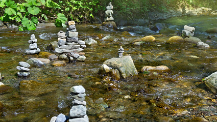 Stack of zen stones, natural pebble rocks stacked on top of each other in stream in a forest. Concept of harmony and balance