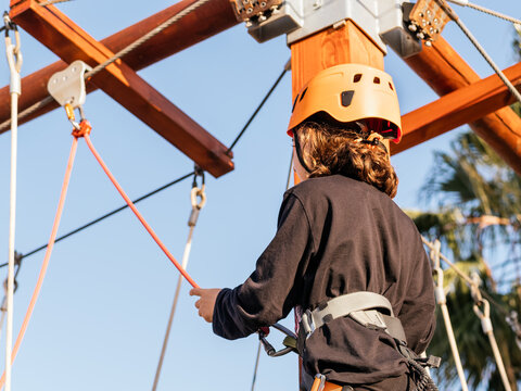 A girl on High Ropes Course with Safety Gear