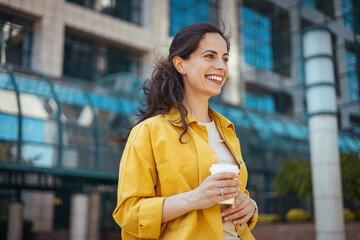 Cheerful Woman Enjoying Coffee Break Outdoors in City