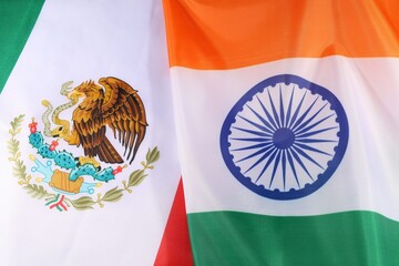 Naklejka premium Flags of Mexico and India displayed together during a cultural event