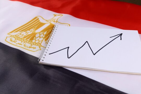Growth trend chart on notepad above the Egyptian flag