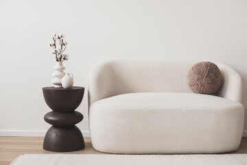 View of modern scandinavian style interior with sofa and trendy vase over white wall, Home staging...