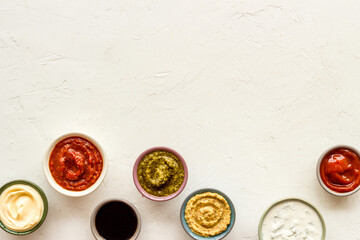 Bowls with various sauces for the meat or vegetables. Food background