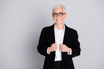 Photo of charming lovely successful senior lady wear black suit isolated on grey color background