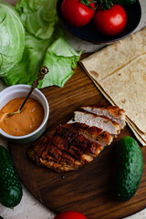 fried chicken meat lies on a plate, before cooking homemade shawarma