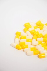 a collection of yellow capsules on a white background