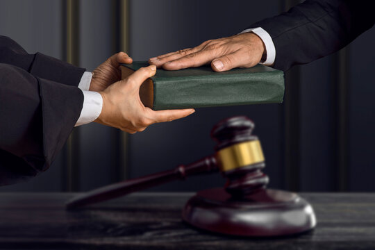 Hand on the Bible in court or the oath on the constitution book. The witness is sworn in