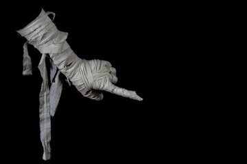 Mummy's hand wrapped in a bandage creepily pointing on isolated background. The hand of the mummy...