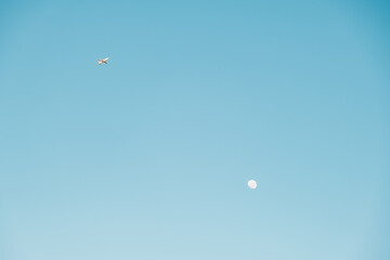 Moon and plane in the sky