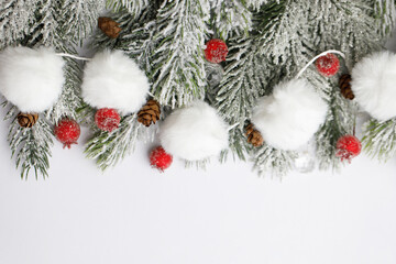 Winter fir tree in white snow, red berry and Christmas decoration on white background. Christmas background border