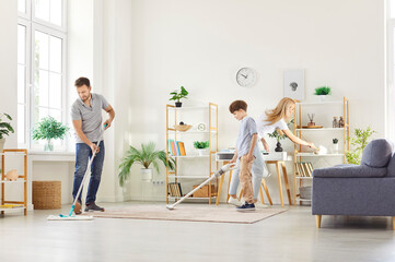 Happy cohesive family doing housework together, cleaning living room, involved in different tasks,...