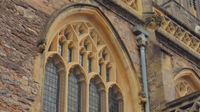 Decorative Window Details of Church of St John the Baptist In Axbridge, Somerset, UK. closeup, low-angle tilt-down