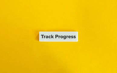Track Progress Phrase. Text on Block Letter Tiles on Yellow Background. Minimal Aesthetic.