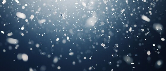 A blue sky with snowflakes falling from it