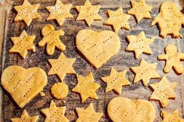 Various shaped cookies on a wooden background with sugar coating