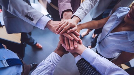 Fototapeta premium Close up top view of business people putting their hands together. Friends with stack of hands symbolizing their unity and supportand teamwork. Team set up for productive work and a positive result.Le