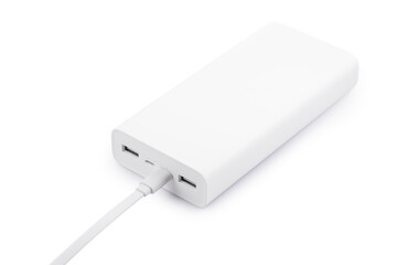 Powerbank for charging mobile devices with cable on white table