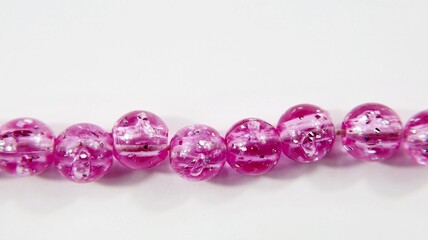Colorful plastic necklace beads white background.