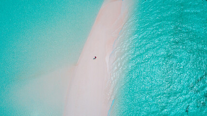 Aerial view of a serene Maldives sandbank with pristine white sand and crystal clear turquoise waters.