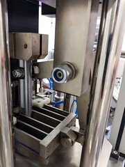 a close-up of  a machine (capsule filler) in a production facility in a pharmaceutical industry