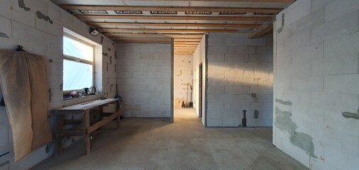 Photo of the inside of a house under construction. The wall material is gas block, the roof is wooden. High quality photo