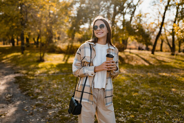 attractive young woman walking in autumn wearing jacket