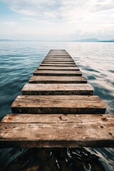 Obraz premium A quaint fishing dock with old wooden planks stretching out over calm water