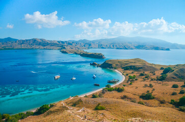 View from the top of the island about the tropical island with fields and blue ocean at Gili Lawa Island, Labuan Bajo, East Nusa Tenggara, Indonesia. © Balnyes Visuals