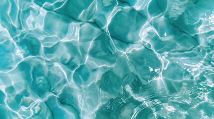 Obraz premium Bright sunlight dances on the surface of turquoise water in a pool, creating ripples and reflections that evoke tranquility and warmth during a summer day