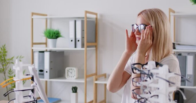 Woman finding, choosing right pair of glasses, perfect correct optical frame, lens at optician, eye care of doctor, visiting ophthalmologist in medical clinic to correct vision, selecting in shop