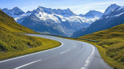 Naklejka premium Scenic road in the Swiss Alps, winding through snow-capped mountains.