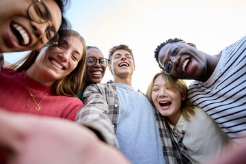 Selfie portrait international Gen z friends group looking excited at camera sunny day outdoors....