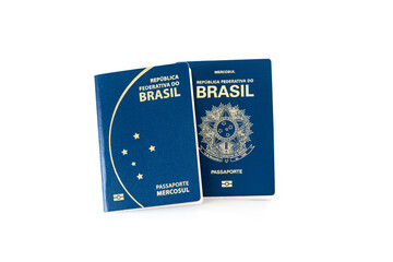 Two different models of Brazilian passport on a white background