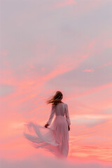 A woman in a white dress is standing on a beach at sunset