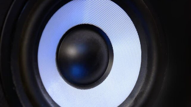Close-up of a speaker moving due to bass sound