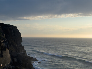 The cliffs stand tall against the vast ocean a silent sentinel watching over the waves below