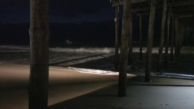 Ocean City, Maryland USA The sea washing up to the beach at night under the Ocean City Pier. 