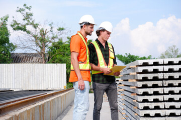 Engineer and Employee Working at Construction Site.