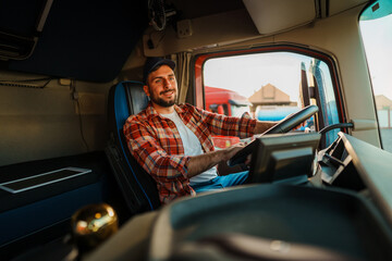 Professional truck driver with a heat and in plaid shirt fastening seat belt before starting a new...