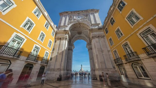 Rua Augusta Arch (Arco da Rua Augusta) timelapse hyperlapse on Praca do Comercio. Historic stone art monument with clock, ornaments and old tourist landmark attraction in Lisbon, Portugal, Europe.