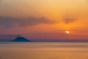 sunset on the sea, in front of the volcano, Italy