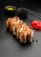 Canada roll with an eel on a black background
