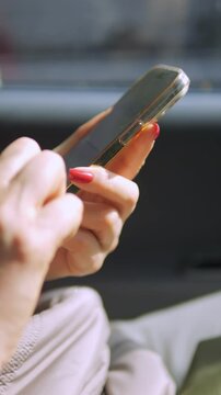An InDepth CloseUp Image Featuring a Hand Skillfully Manipulating a Smartphone Inside a Vehicle