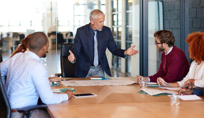 Speaking, people or architecture director in meeting for engineering, discussion and building project. Business, paperwork and designers talking in office for development, blueprint and documents