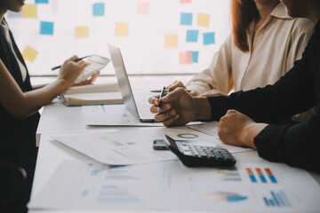 Financial analysts analyze business financial reports on a digital tablet planning investment...