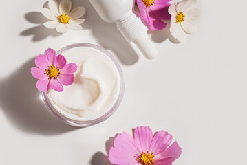 Organic cosmetic products with delicate pink flowers