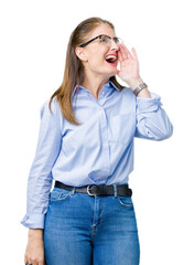 Beautiful middle age mature business woman wearing glasses over isolated background shouting and screaming loud to side with hand on mouth. Communication concept.