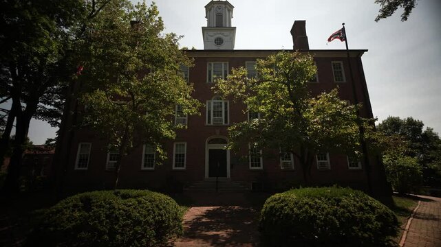 Cutler Hall on the College Green view through the trees at University of Ohio in Athens OH.